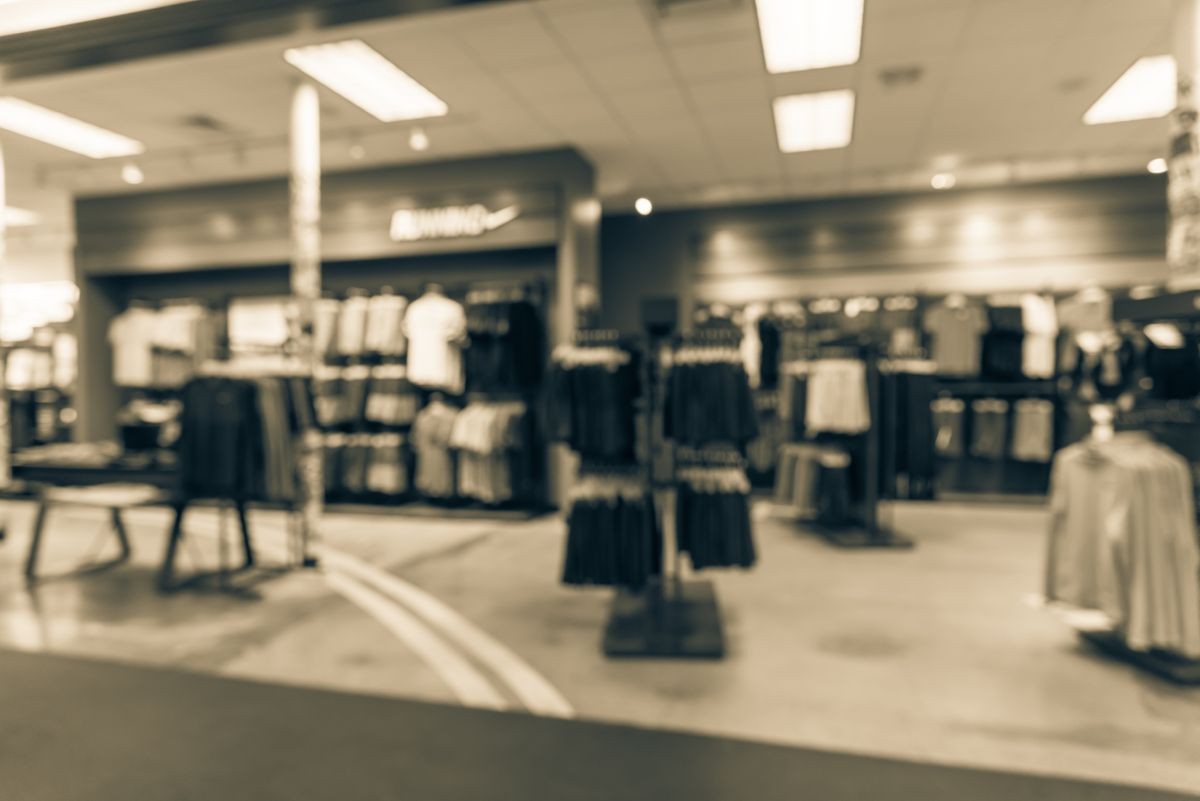 Blurred image interior of sports and fitness clothing store in America. Sport shop with famous sports fashion brand worldwide of athletic shoes, gear, apparel. Healthy lifestyle concept. Vintage tone.