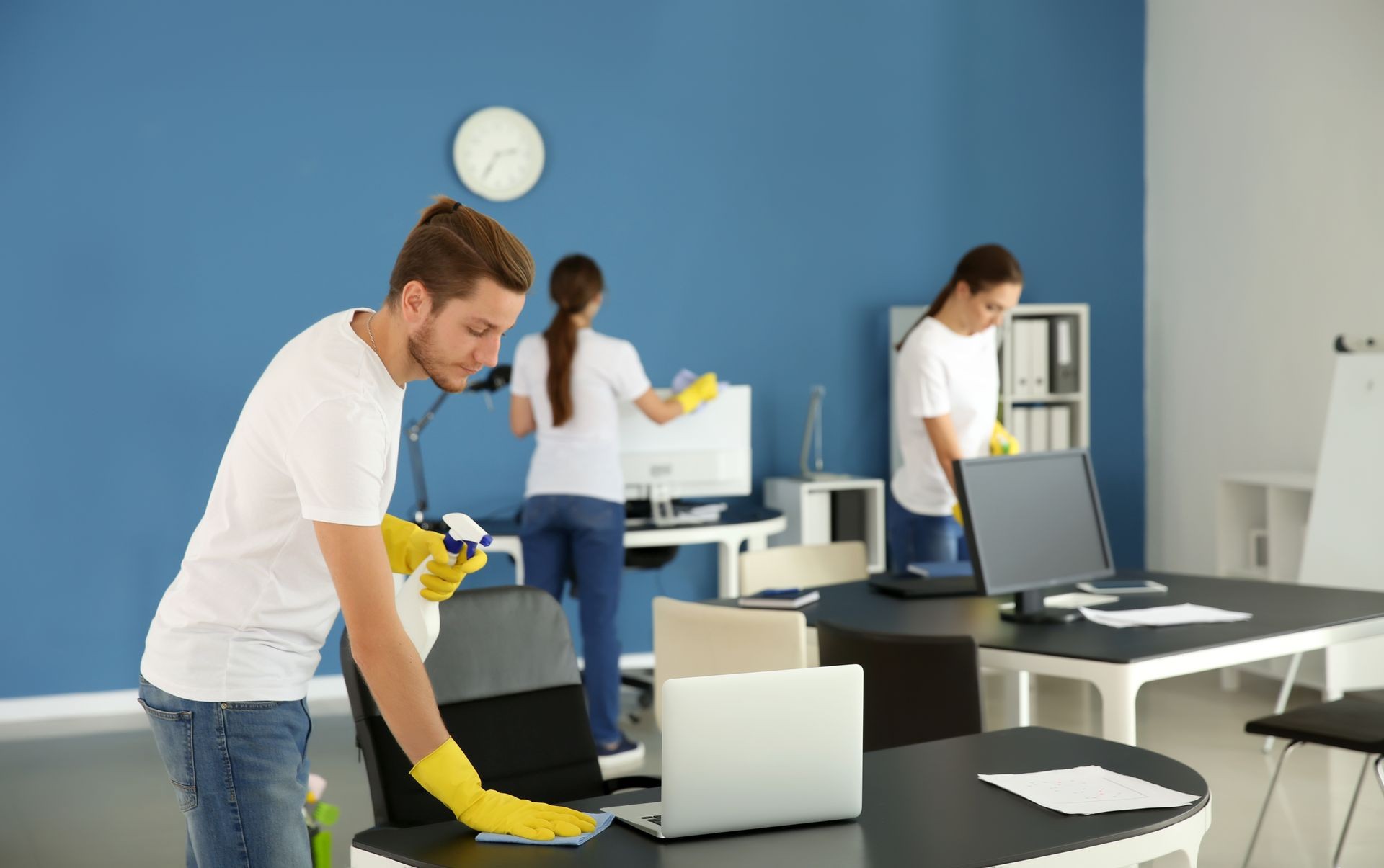 Team of janitors cleaning office